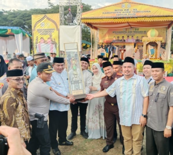 SERAHKAN: Bupati Aceh Tenggara HM Salim Fakhry SE MM bersama Unsur Forkopimda, saat menyerahkan Piala Bergilir kepada Camat Lawe Sigala gala Ary Syafrizal Arma didampingi isteri, selaku peraih juara Umum MTQ Ke 40 Tingkat Kabupaten Aceh Tenggara, pada acara penutupan MTQ, di Lapangan Pemuda Babussalam, Senin (28/7/2025).(Foto/Dok/Ist).